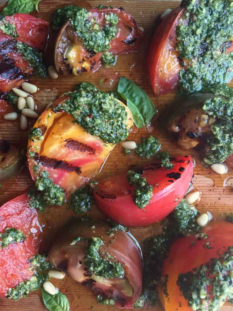 AMAZING Grilled Pesto Tomatoes! The perfect side for any summer get together! Sweet grilled tomatoes + super flavorful (dairy free) basil pesto! YUM! #dairyfree #vegan #recipe | Peach and the Cobbler